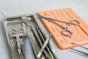 Suturing human skin medical silicone pad and surgical instruments for practice © frimufilms