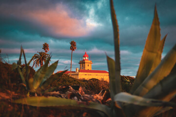 lighthouse at sunset in lagos portugal algarve