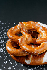 Bavarian delicious freshly baked homemade soft pretzel on dark background. Close up pretzel salt selective focus. Octoberfest.