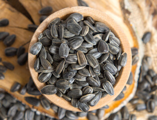 raw unshelled sunflower seeds on a rustic background. seeds on an old tree