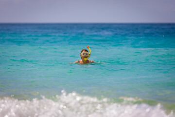 A girl in a mask jumps out of the sea