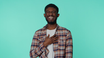 Bearded adult african american man laughing out loud after hearing ridiculous anecdote, funny joke, feeling carefree amused, positive people lifestyle. Young guy isolated alone on blue background