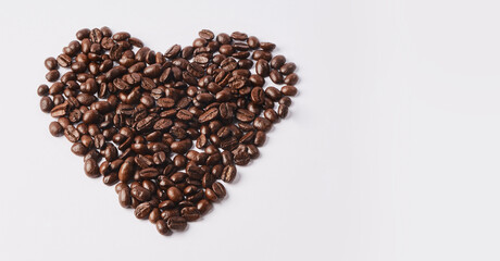 Who doesnt love coffee. Studio shot of coffee beans shaped in a heart against a white background.