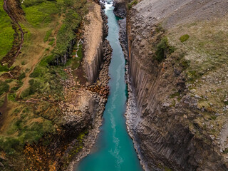 Beautiful aerial view of the studlagil canyon, and the largest number of basalt rock columns in...
