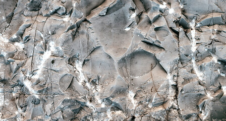 Silver Wall. Rock background. Rock texture. Dark marble. Stone background. Rock pile. Paint spots. Rock surface with cracks. Grunge Rough structure. Abstract texture.