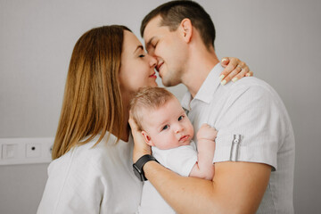 a happy family with a newborn baby at home. mom, dad and baby.