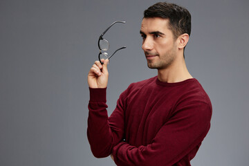 portrait smart man in a red sweater with glasses posing self confidence elegant style