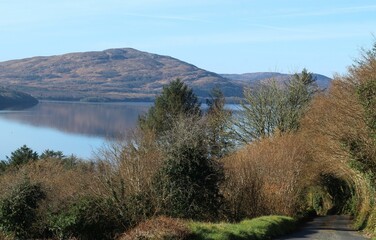 View from road of rural County Leitrim, Irelnad featuring  Killery Mountain reflecting into still waters of Lough Gill