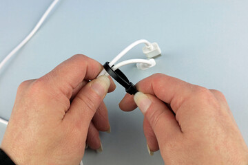 A black cable tie being used to secure cables together.