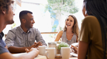 Catching up with old friends. Shot of a group of friends talking in a cafe.