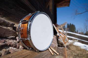 snare drum outside with drumsticks.                                                                ...