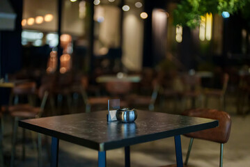 Table in outdoor restaurant in summer at night.