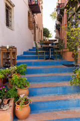Small narrow street with blue stairs in Old Town of Rethymnon, Crete island, Greece