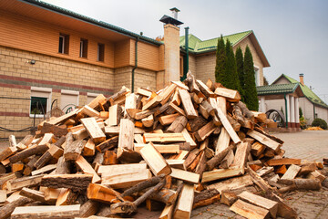 A pile of split firewood for heating the house.