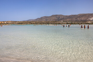 Fototapeta na wymiar People relaxing on the famous pink coral beach of Elafonisi on Crete, Mediterannean sea, Greece