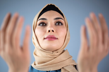 muslim woman praying with hands open up