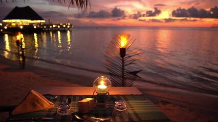 Served tables in the restaurant on the ocean in anticipation of visitors at sunset.