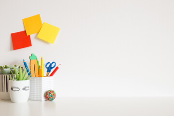 Mock up young student desk, with yellow supples, mannequin, notebook and copy space.	