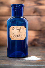 ancient apothecary blue jar with a label where it is written 