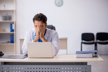 Young male doctor working in the clinic