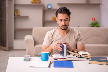 Young male student studying at home during pandemic