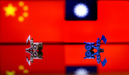 Conceptual image of war between China and Taiwan using toy soldiers and national flags