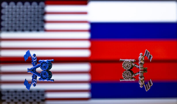 Conceptual image of war between United States and Russia using toy soldiers and national flags