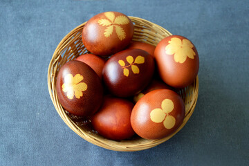 Top view of Easter basket. Naturally dyed eggs with onion skins in basket
