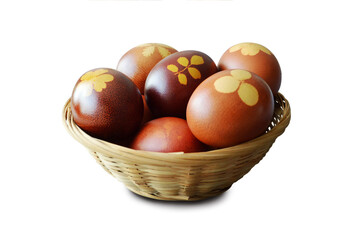 Easter eggs in basket. Naturally dyed eggs with onion skins isolated on white background.