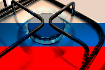 Close up of Household gas burner blue flame, national flag of state russia on the burner of a gas...