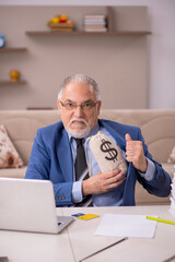 Old male boss working from home in remuneration concept