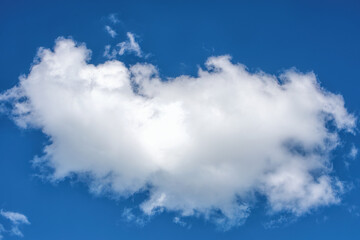 Fluffy white clouds on background of blue sky.