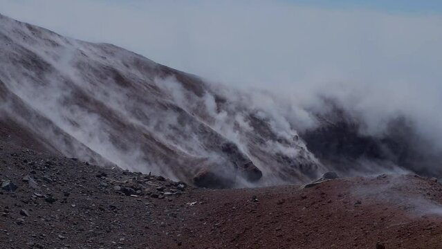 Caldera of Avachinsky stratovolcano, also known as Avacha Volcano. Swinging steam from hot geysers. Kamchatka Peninsula, Russia.
