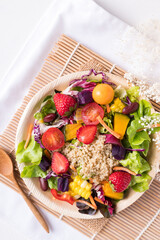 Fresh mixed fruits and vegetables salad in natural plate on white background, Healthy vegan food, Top view