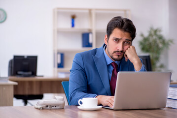 Young male employee working in the office