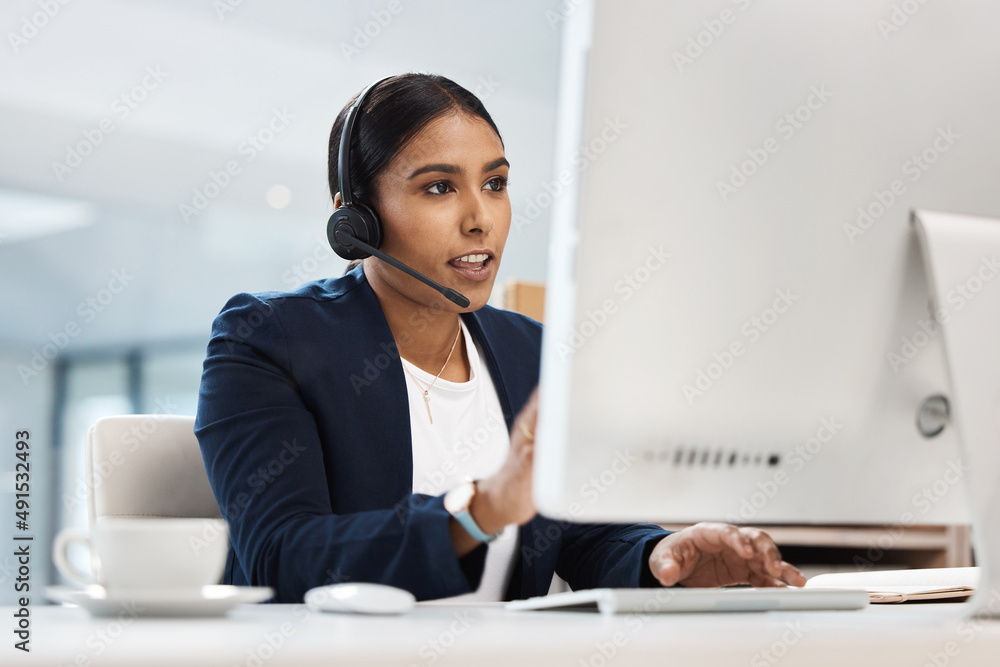 Poster communicating in an effective manner. shot of a young businesswoman working on a computer in a call 