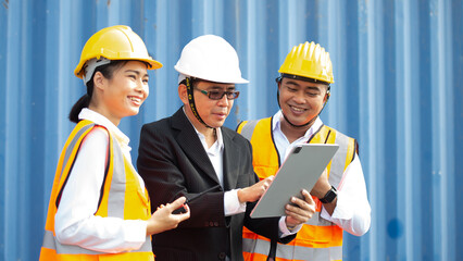Worker use Tablet about business working at the port for transfer products.