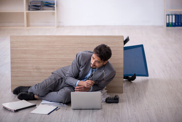 Young male employee working overtime in the office