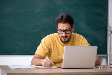 Young male student in telestudying concept