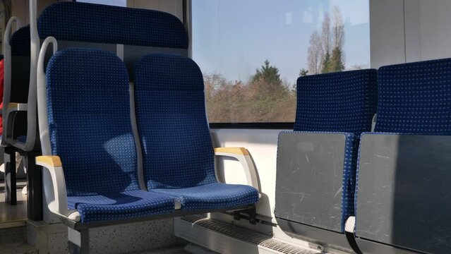Selected focus view at empty seat on the moving Light rail tram and exterior view of countryside of Germany through window. Enjoy moment during commute and travel by Tram in Europe.