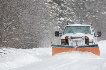 Truck plowing a road during a winter storm in Ontario