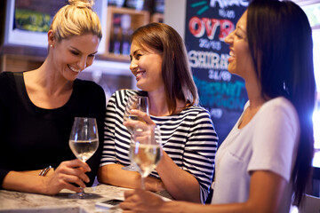 Girls night. A cropped shot of three woman socializing in a restaurant.
