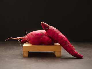Japanese sweet potato on a wooden with a black background