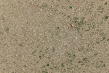 a man standing on dry cracked earth with copy space. metaphor climate change and water crisis, Aerial shot top view