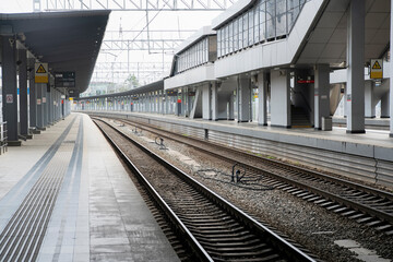 Deserted platform at the railway station without people.