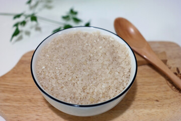 Raw rice is in the bowl.
