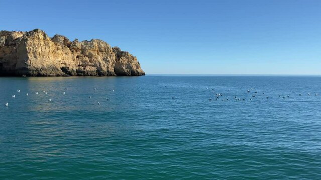 Boat traveling along coast of Portugal