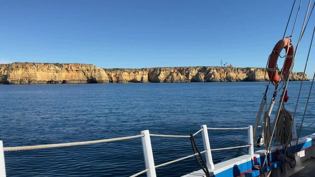 Boat traveling along coast of Portugal