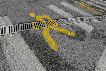 close-up of a pedestrian crossing with a yellow person icon