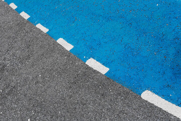 Close-up road, asphalt with intermittent markings